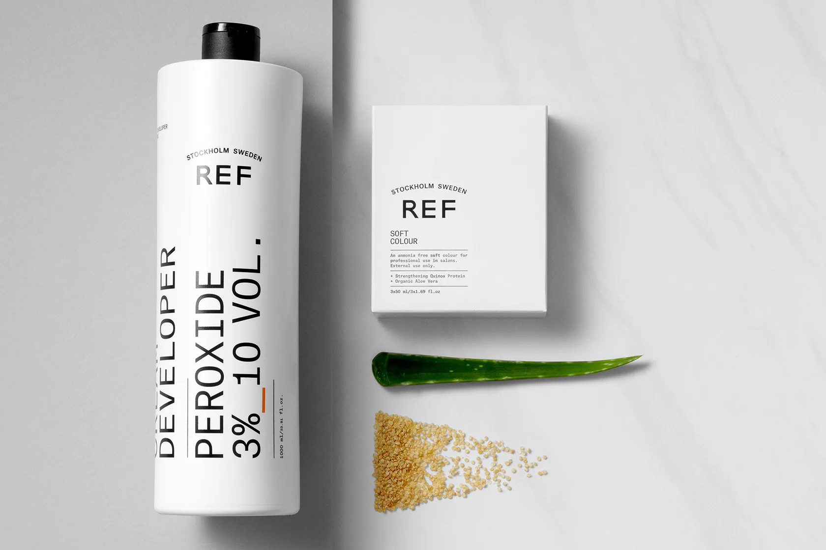 REF Stockholm developer peroxide bottle with Soft Colour box, aloe vera, and quinoa seeds.