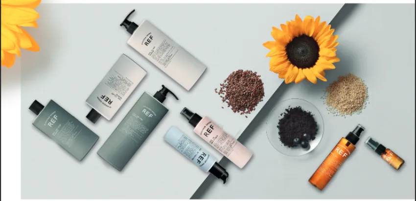 REF Stockholm hair care product range laid flat with sunflower and natural ingredients.