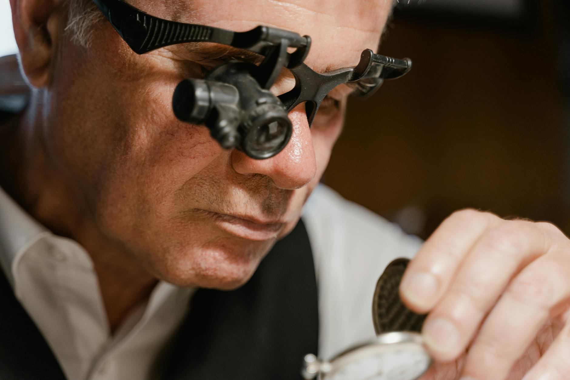 watchmaker inspecting movement
