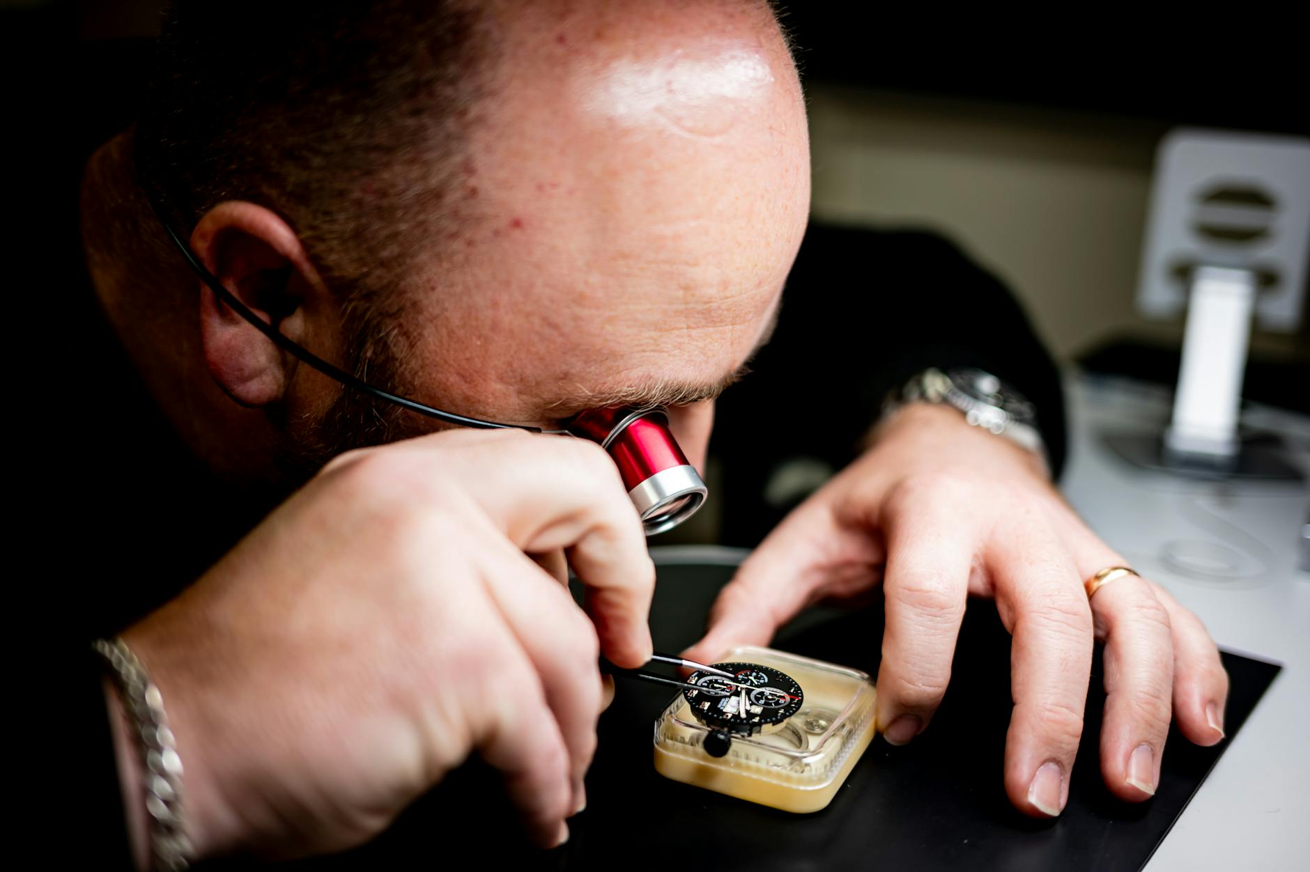 watchmaker inspecting movement