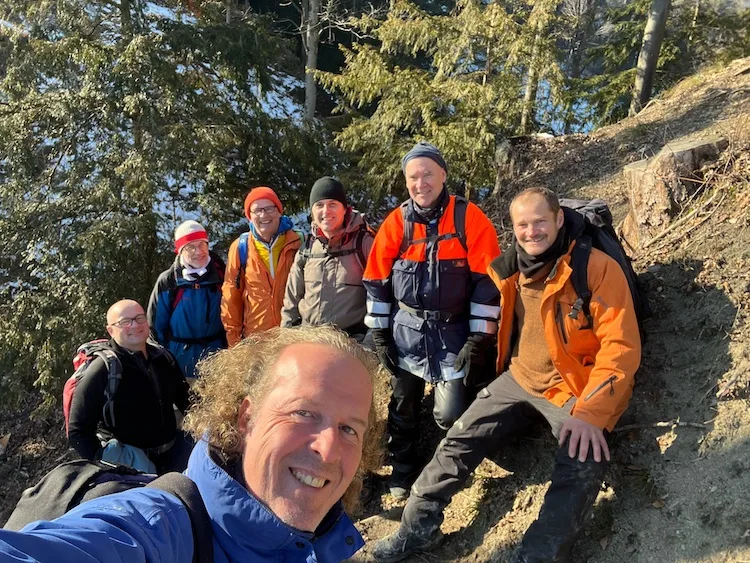 Group of men taking a winter forest selfie during a hike — captures the community and brotherhood central to Gasser-Kehl's vision.