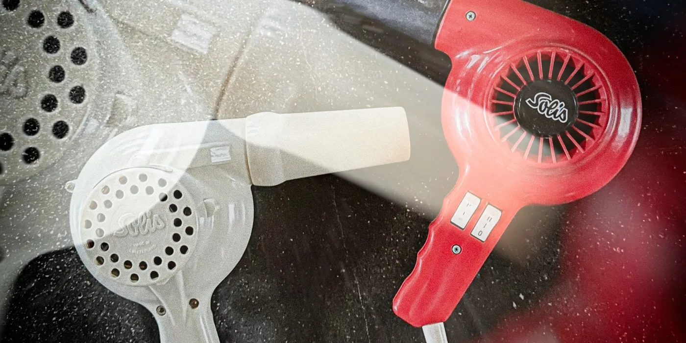 Red and white Solis hair dryers laid flat, showing classic retro design and brand detail.